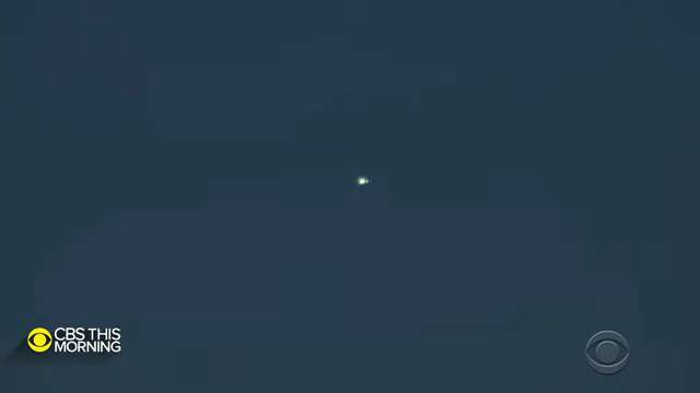 an irregularly shaped light is visible against a navy/denim-blue sky. There's a CBS THIS MORNING watermark is visible in the lower left