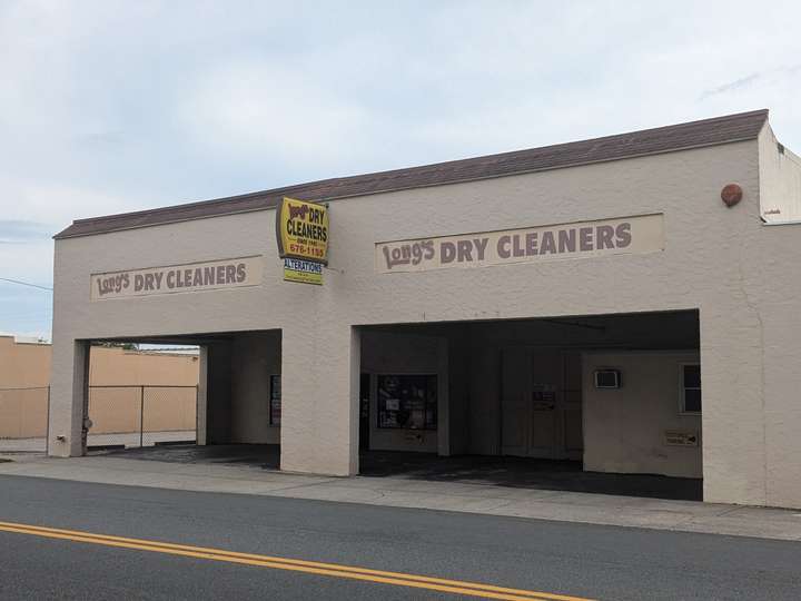 A plain stucco building with a hollow front