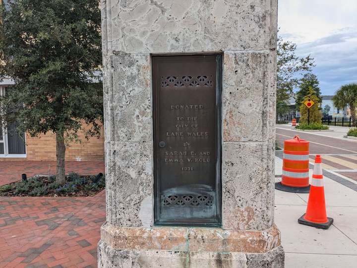 A close up of a metal plaque that reads 