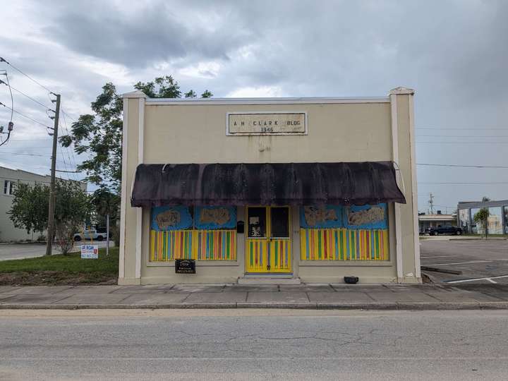 A tan, one story building with an awning