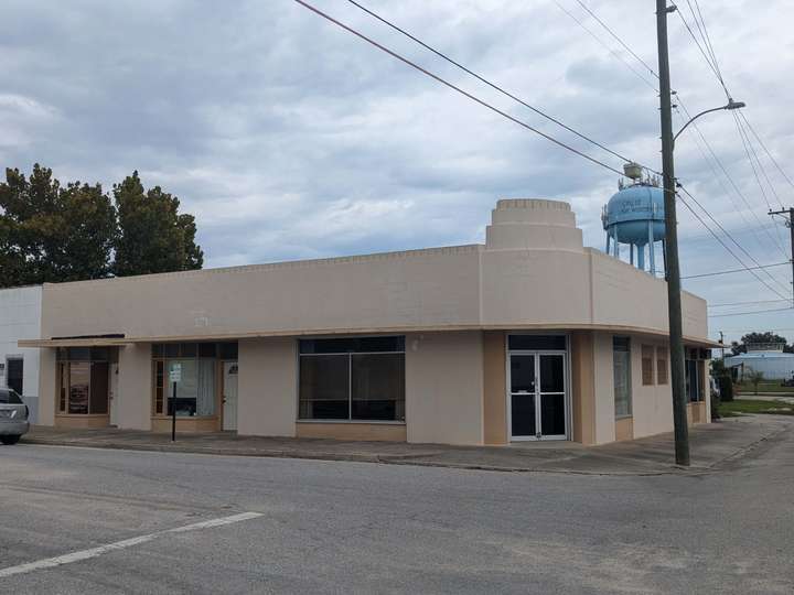 A one story corner building with a rounded design