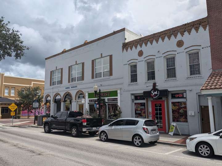 a view of two white, 2-story buildings