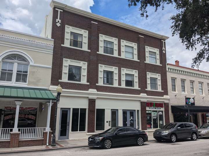 a 3-story brick building with large accents around the 2nd & 3rd floor windows