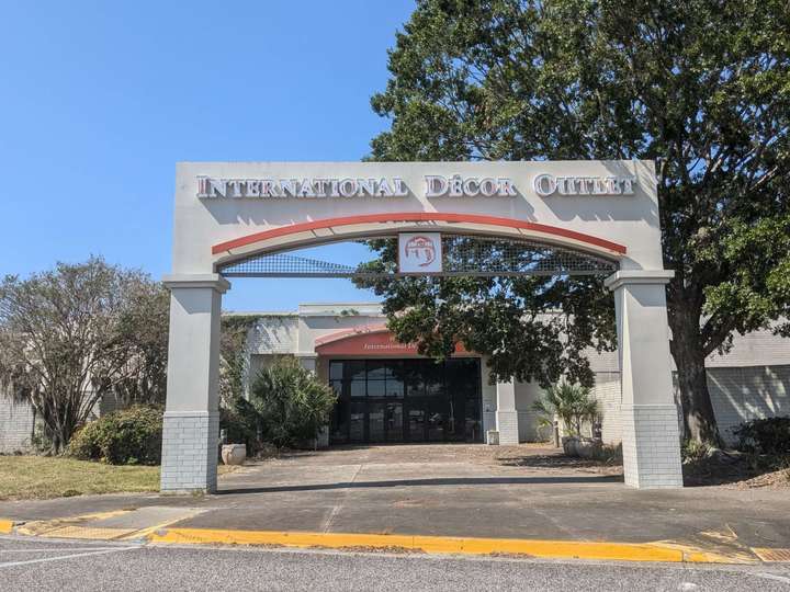 a white gate with orange accents framing a mall entrance