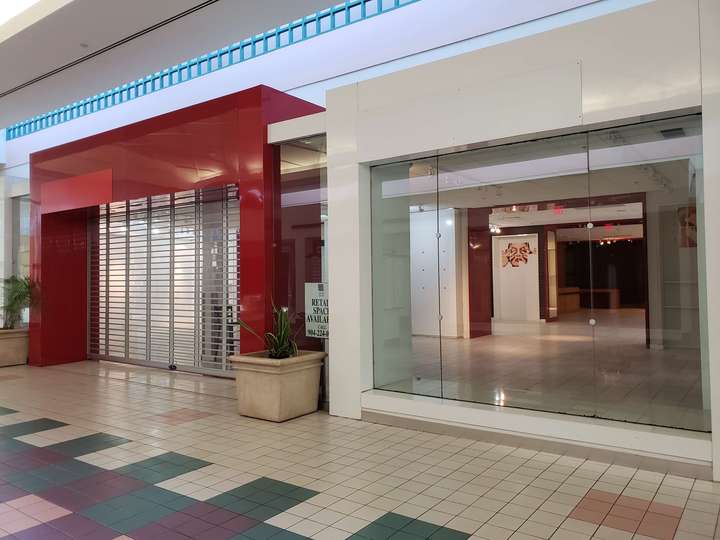 A vacant red and white geometric storefront