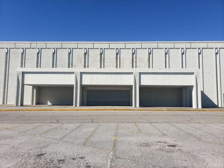 A brutalist, white brick department store exterior