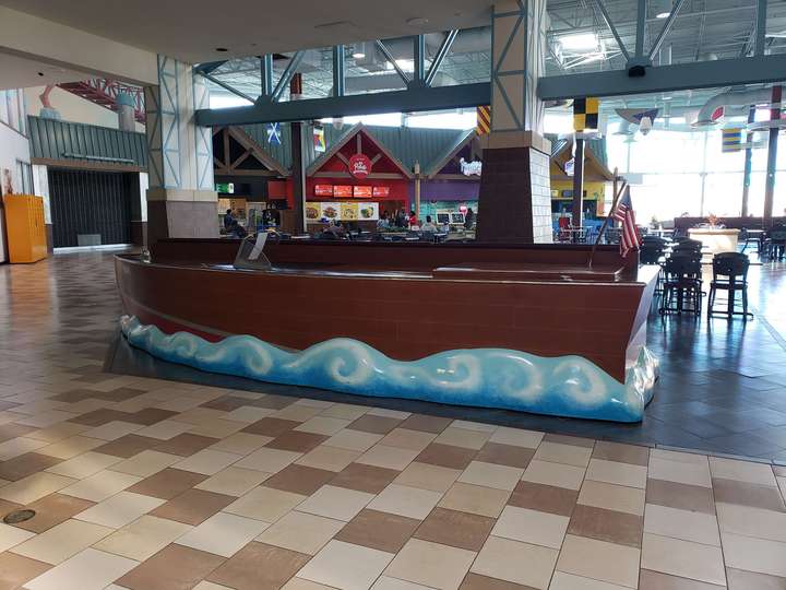 A fiberglass desk, themed as a small wooden boat riding the waves