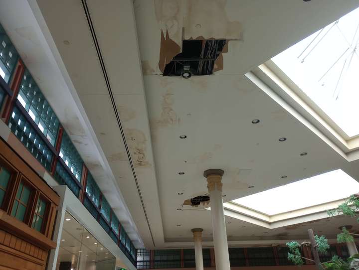 two tears in the mall ceiling amid large amounts of water staining