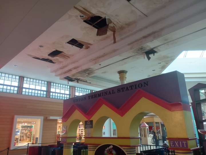 Several tears in the ceiling amid large water stains, over a kids play area