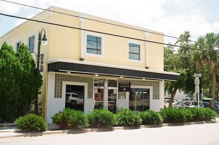 A cream colored building with glass blocks above the windows