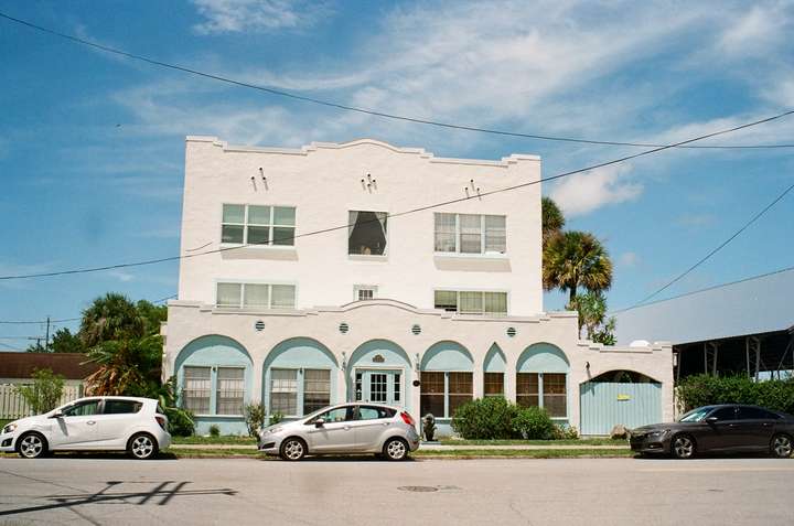 A white and baby blue setback apartment building