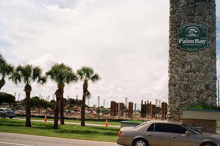 A tilted shot showing the sign from above beside new apartment construction