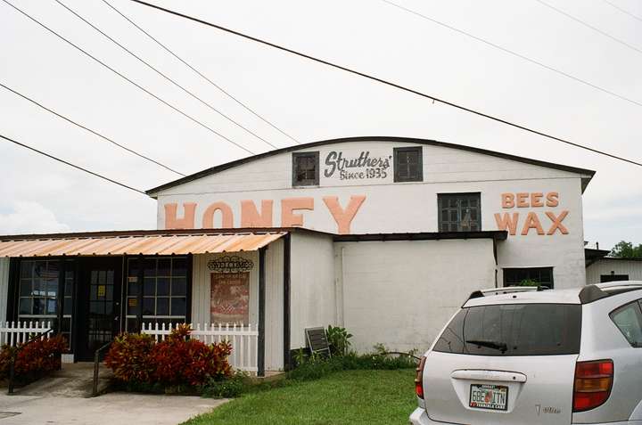 The end of a round-topped building, with a small store in front