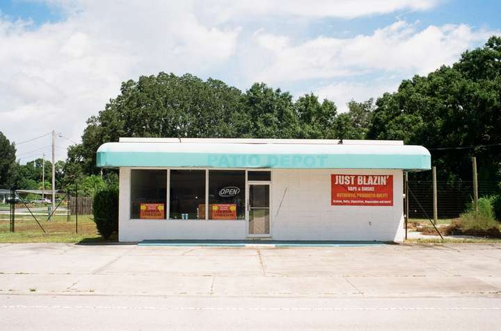 A one-story shop with an offset door and windows