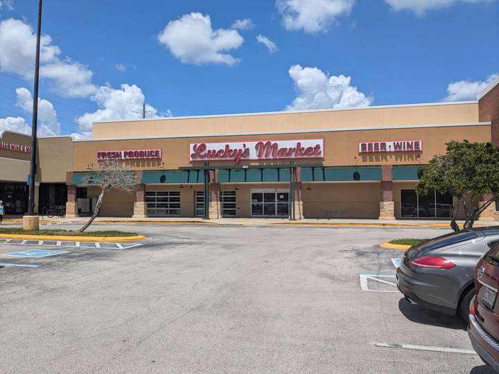 A terracotta-colored supermarket with a red on white sign