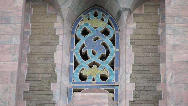 A blue and green tile mosaic of fish