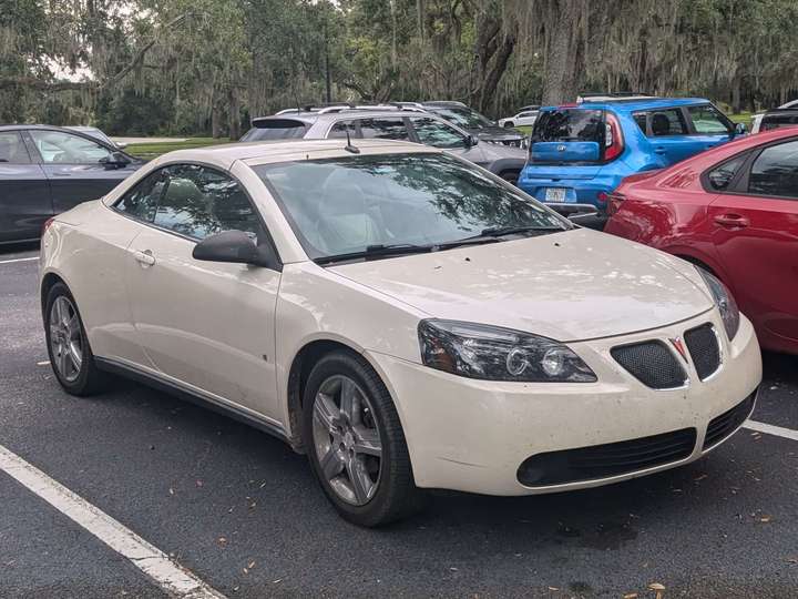 A cream colored Pontiac coupe