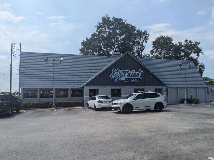 A long A-framed building with a center A-frame protrusion