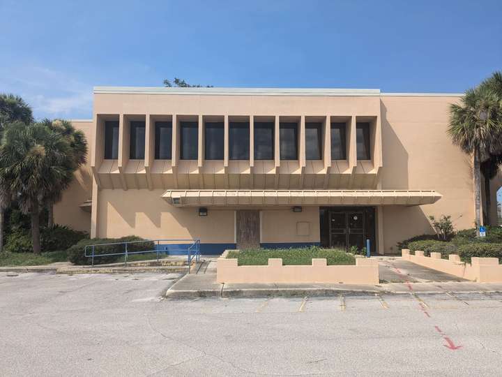 a vent-like facade on a beige brutalist bank