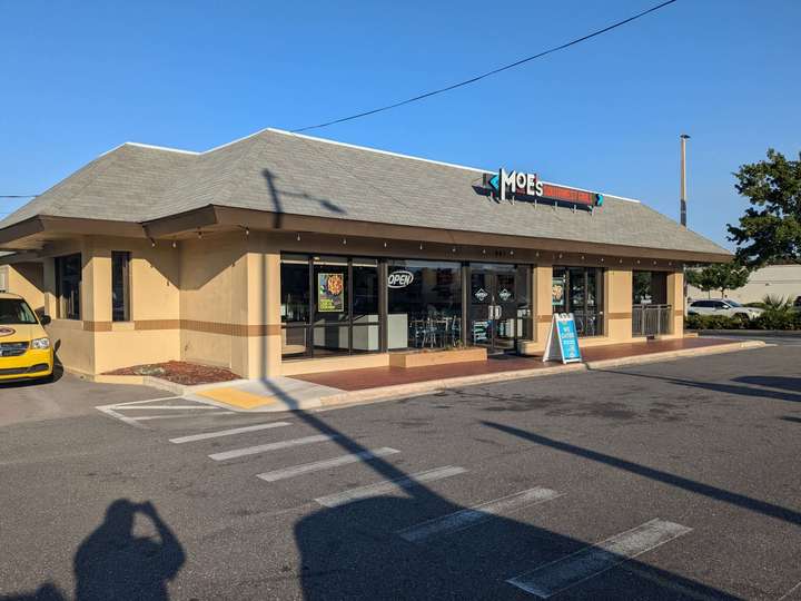 a beige and gray-roofed fast food building