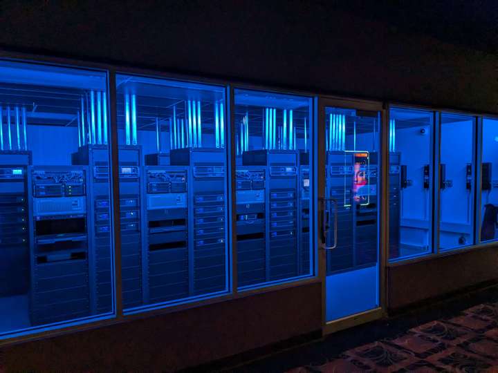 A movie theatre computer room lit by blue light