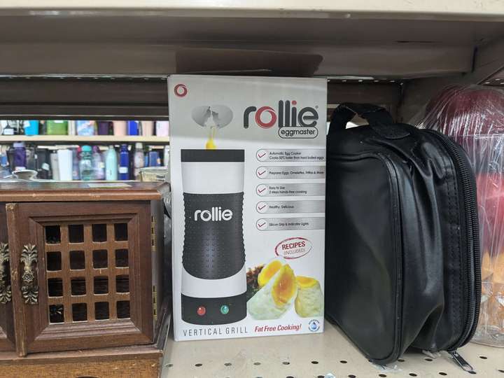 a boxed Rollie 'vertical grill' on a shelf