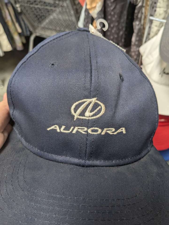 A dark blue hat branded for the Oldsmobile Aurora