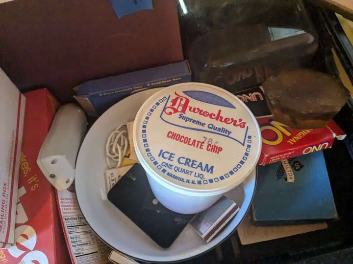 An empty plastic quart tub of ice cream