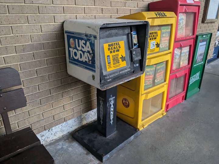 A derelict newspaper box