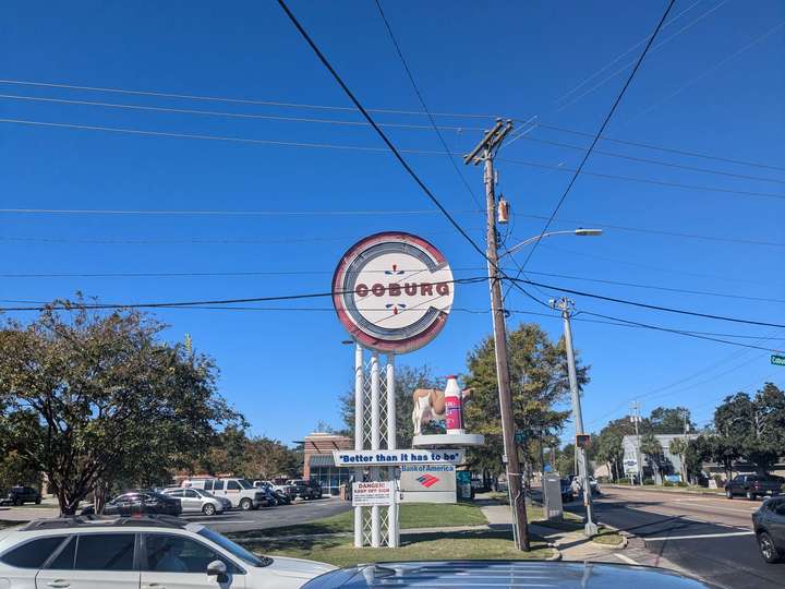 A large sign for a milk company with a rotating cow