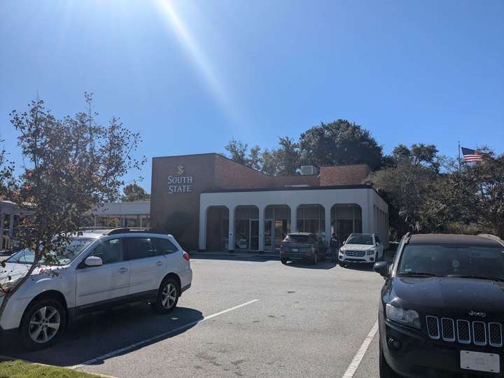 A bank building with simple arches over the entrance