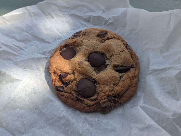 a chocolate chunk cookie with large, circular chunks visible