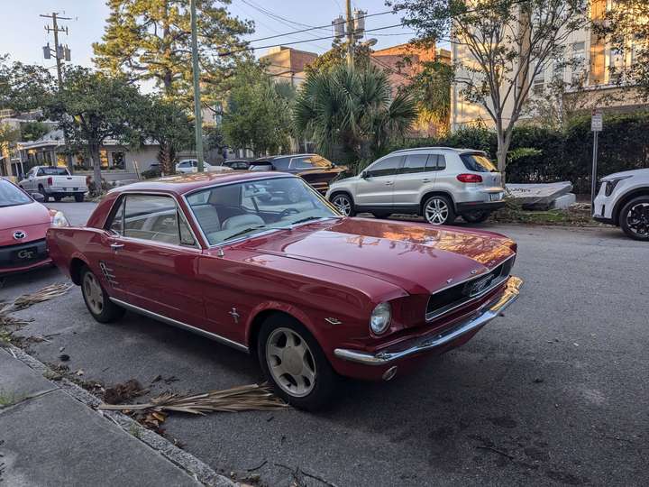 a street parked red Ford Mustang