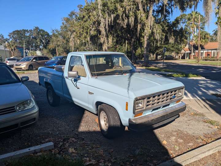 a baby blue single cab small pickup truck