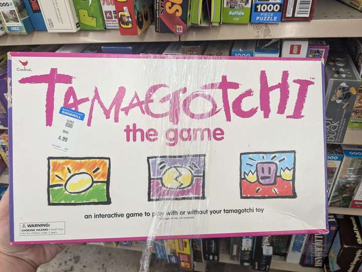 a box for a Tamagotchi-themed board game