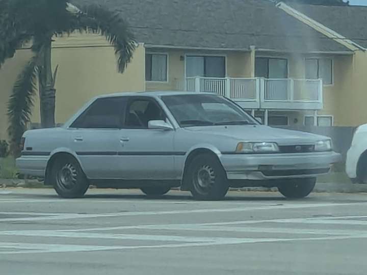 a boxy silver economy sedan