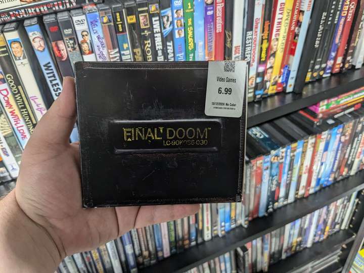 a mostly black paper CD case for a game called Final Doom