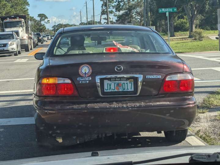 a rear view of a maroon sedan