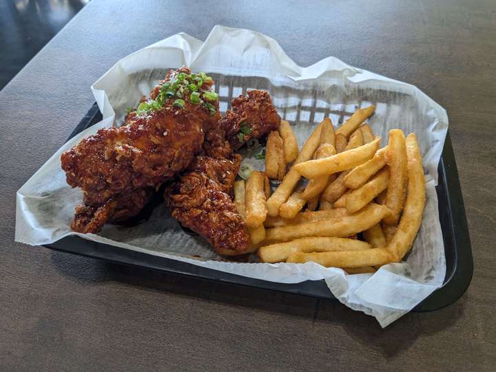 A basket of Korean fried chicken with fries