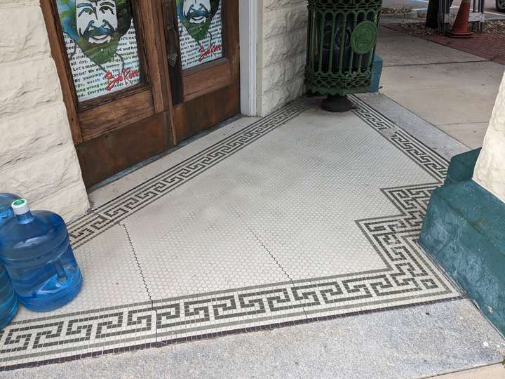 a corner entrance, outlined with an elaborate interlocking style pattern