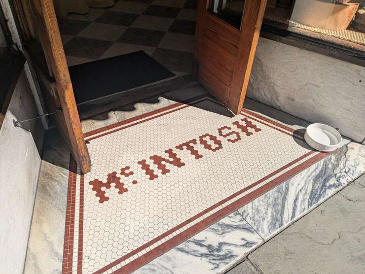 McIntosh is spelled out in hexagonal tiles, framed by square tiles of red and white