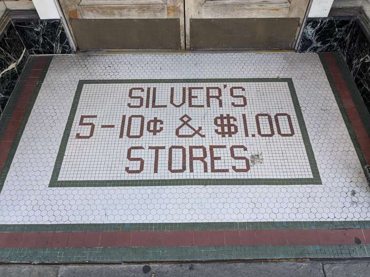 SILVER'S 5-10c & $1.00 STORES is spelled in red text, framed by a green line