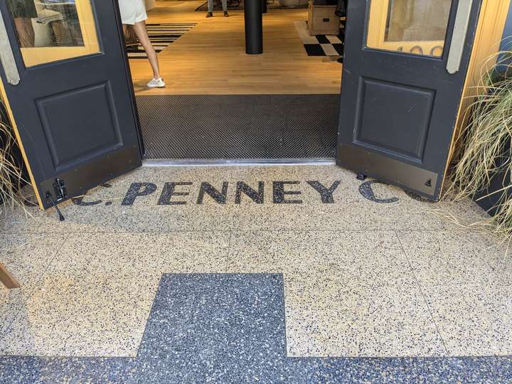 a lighter sand yellow entrance, with J.C. Penney Co spelled out in graphiteish gray