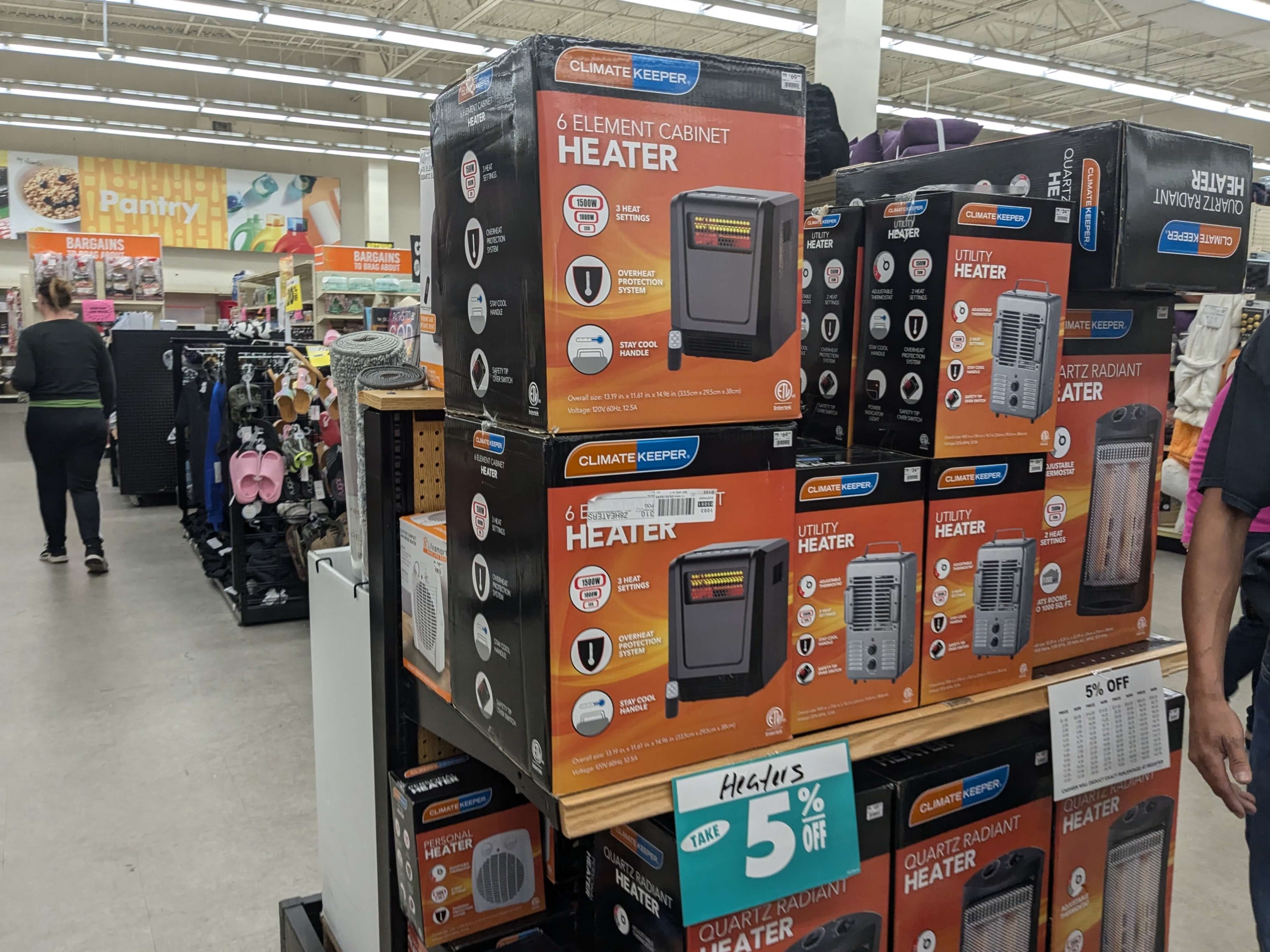 a full display of space heaters, marked at 5% discount