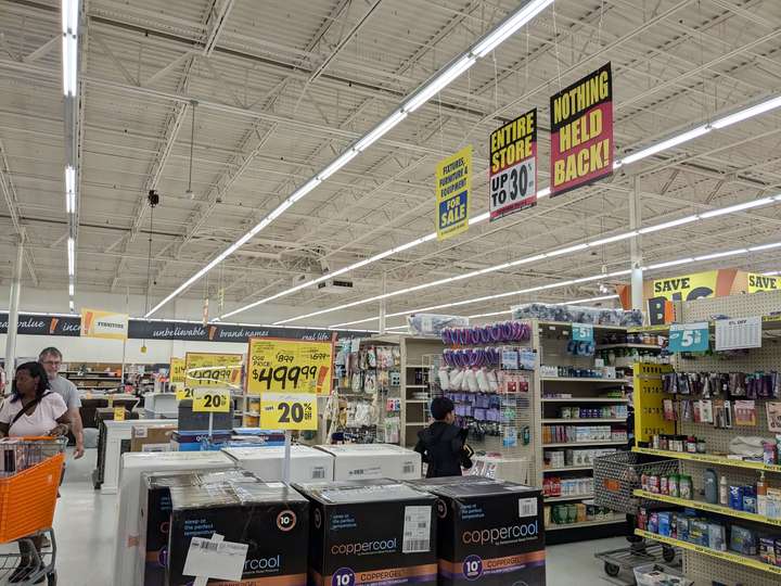 A store interior view showing shelves of product and store closing signs