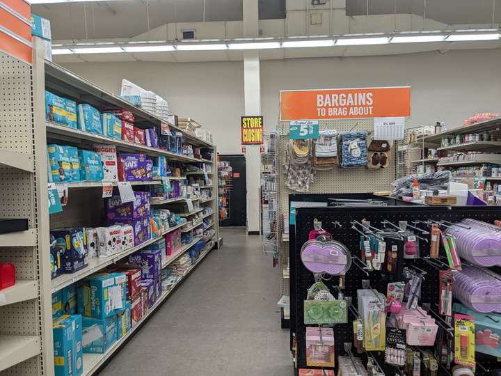 A view down an aisle with a lower half-height shelf on one side