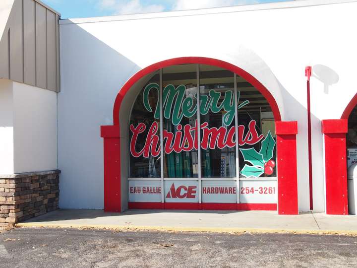 A closeup of one scalloped window, with Merry Christmas painted on the glass