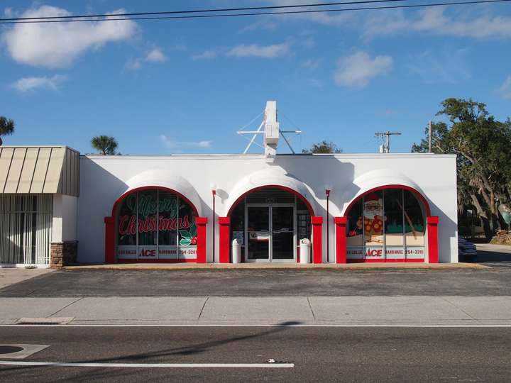 A scalloped red and white store facade, shot head on