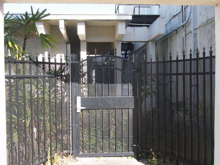 A puleld back shot of a fence blocking the same courtyard