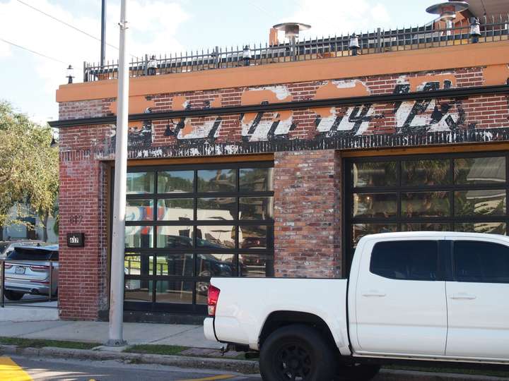 A ghost sign that barely reads Carrol's on a brick building